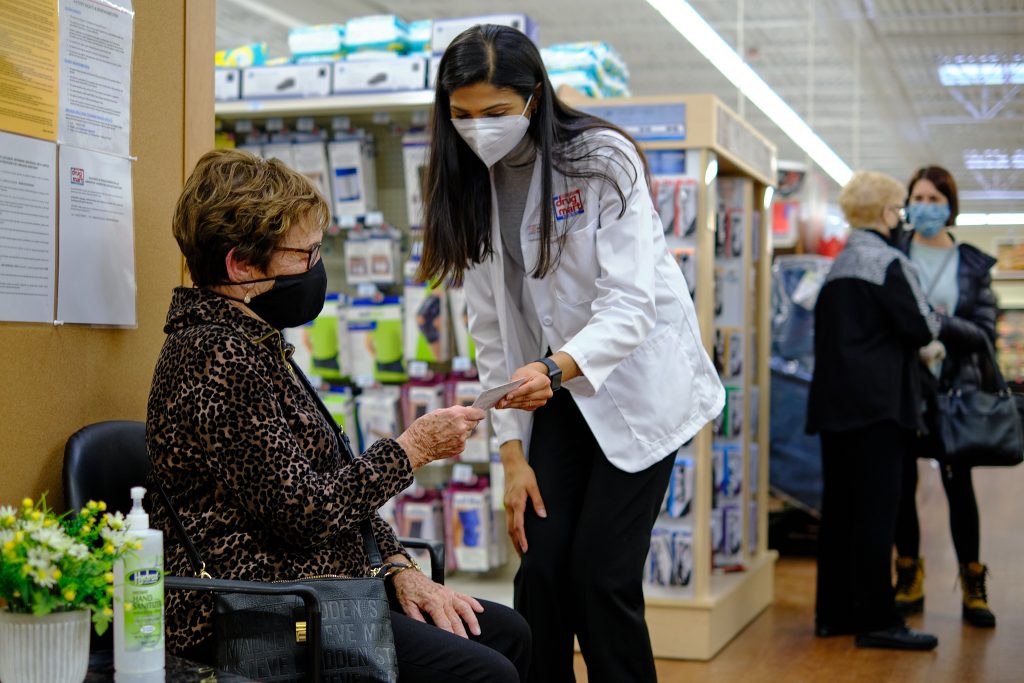 Pharmacist explaining prescription to customer at a Discount Drug Mart Pharmacy 